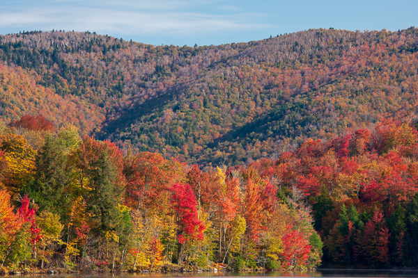 Autumn;Blue;Bluff;Botanical;Branches;Brown;Calm;Cloud;Cloud Formation;Clouds;Fall;Forest;Forested;Gold;Healing;Herbaceous;Hill;Leaf;Mountain;Mountain Side;Mountainous;Mountains;Nature;Pastoral;Tan;Timber;Timberland;Tree;United States;Vermont;Waterscape;Wood;Woodland;Woods;Yellow;botanicals;foliage;green;hillside;lake;landscape;leaves;limbs;oneness;orange;peaceful;plants;pool;red;reflection;restful;serene;soothing;tranquil;tree limbs;tree trunk;trees;trunk;zen
