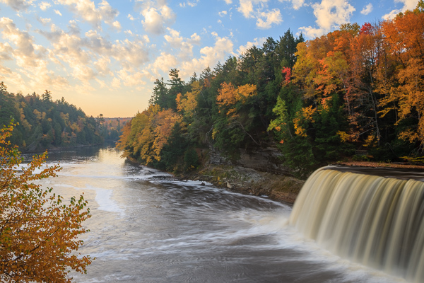 Autumn;Blue;Brown;Calm;Cascade;Cascading;Chute;Cloud;Cloud Formation;Clouds;Cloudy;Creek;Fall;Falls;Flow;Forest;Forested;Gold;Great Lakes;Healing;Michigan;Nature;Pastoral;Pouring;River;Spilling;Stream;Streaming;Sun-up;Sunlight;Sunshine;Tahquamenon Falls;Tan;Timber;Timberland;Tree;United States;Upper Peninsular;Water;Waterfalls;Waterscape;Wood;Woodland;Woods;Yellow;dawn;daybreak;flowing;green;landscape;leaves;morn;morning;oneness;orange;peaceful;rapids;restful;river bank;serene;sky;soothing;sunlit;sunrise;sunup;tranquil;trees;waterfall;zen